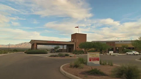 Slow motion POV driving up to emergency entrance of small hospital. Stock Footage 163777138