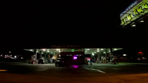 Slow motion POV side pan Raceway gas station people and cars at night 3.83 a  Stock Footage 177671704