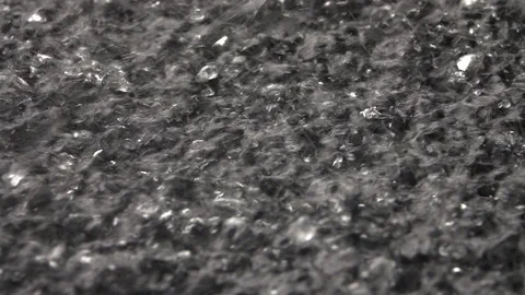 Slow motion of powerful waterfall on water surface and dancing drops close up. Stock Footage 99146763