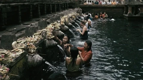 Slow motion Praying at a water temple in Bali Stock Footage