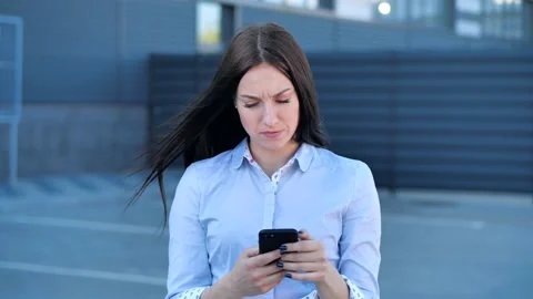 Slow motion of pretty girl using smartphone in street touching screen smiling. 4 Stock Footage 132857894