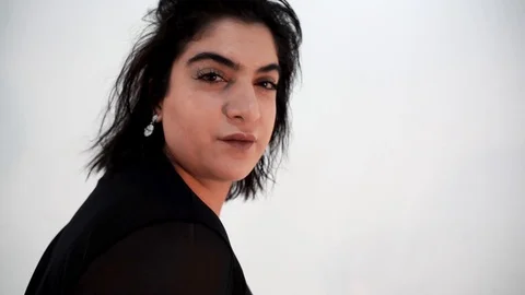 Slow motion of pretty plus size model and flying in air dress looking at camera Stock Footage 103859151