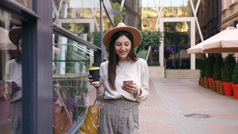Slow motion of pretty smiling young lady in stylish hat which standing near Stock Footage 120186122