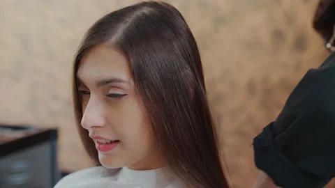 Slow motion. Pretty young client in a barber shop sitting and professional ba Stock Footage 153882260