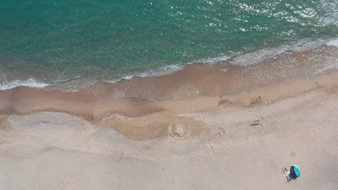 Slow-motion pristine tropical beach aerial top down with sunbather  Stock Footage 112714555