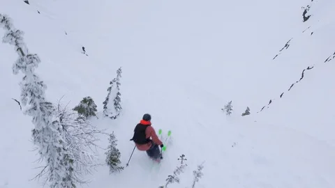 Slow Motion of pro skier doing backflip from hill and landing on snow, Canada Stock Footage 121585363