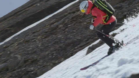 Slow Motion of pro skier in red jacket freeriding in rocky terrain, Iceland Stock Footage 124228687