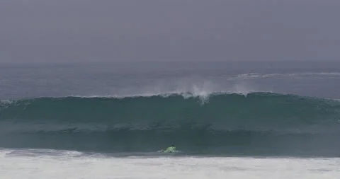 Slow motion of pro surfer Garrett McNamara jumping underwater to dodge wave Stock Footage 156005112