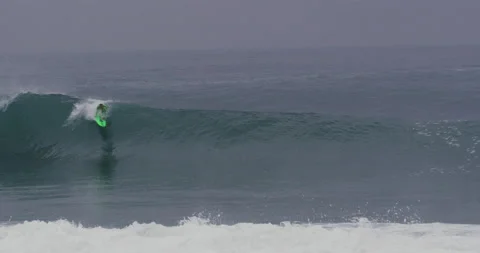 Slow motion of pro surfer Garrett McNamara riding barrel wave that closes on him Stock Footage 156005301