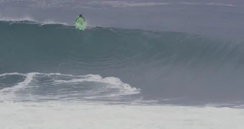 Slow motion of pro surfer Garrett McNamara paddling over big ocean wave Stock Footage 156005443