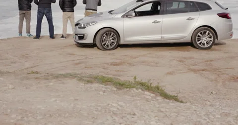 Slow motion of pro surfers standing next to car and watching wavy ocean Stock Footage 164322432