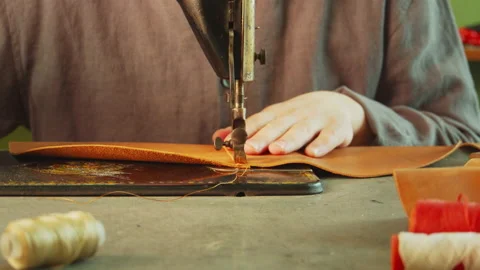 Slow motion is the process of making and sewing a leather bag. Close-up of a Stock Footage 143878947