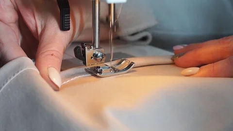 Slow motion of a professional sewing machine stitching with white thread an Stock Footage 83460255