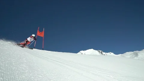 Slow motion professional skier in race suit skiing giant slalom Stock Footage 115970104