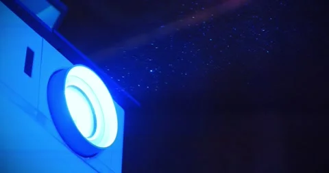 Slow Motion Projector in operation. Dust in cinema hall is visible in light ray Stock Footage 283398112