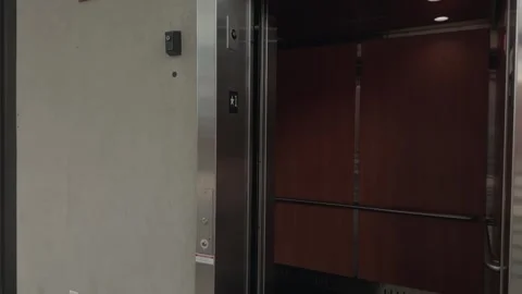 Slow Motion Pull Back as Elevator Doors Close in Modern Interior Stock Footage 327340579