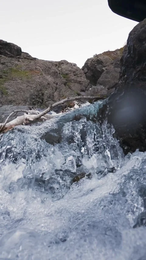 Slow motion pull back reveal of mountain waterfall Stock Footage 330441135