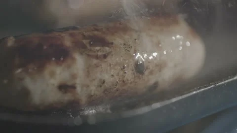 Slow Motion Pull Focus of Sausage Being Cooked Stock Footage 159871759