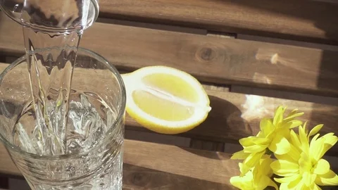 Slow motion pure water flows beautifully into the glass on the table Video stock 88662710
