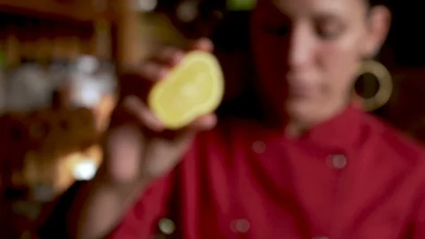 Slow motion push in of an attractive Hispanic woman squeezing an orange Stock Footage 123470867