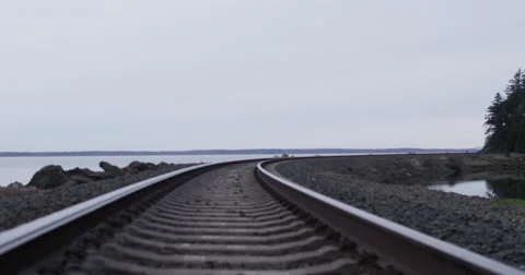 Slow motion push with DJI Ronin across railroad tracks on Northwest bay Stock Footage 57705815