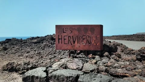 Slow motion push on rusted Los Hervideros sign, Lanzarote, Canary Islands Stock Footage 346375978