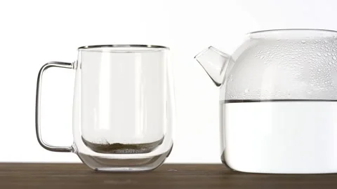 Slow motion of putting instant tea in a glass cup and pouring hot water Video stock 144431571