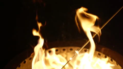 Slow motion putting sparkler into firepit Video stock 170375306