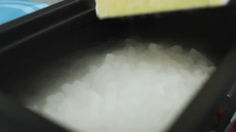 SLOW MOTION putting test viles of a virus into a bucket of dry ice Stock Footage 127532511