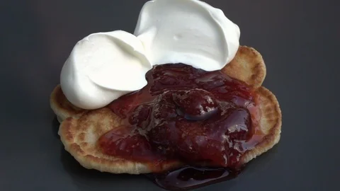 Slow motion of putting yoghurt on batter cake with strawberry jam close up. Stock Footage 100235917