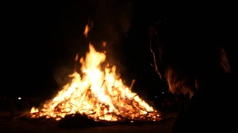 Slow motion quick pan of girl by fire Stock Footage 122355637