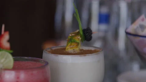 Slow motion rack focus of frozen cocktails on restaurant bar counter in Mexico 動画素材 204713132