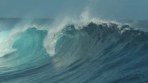 SLOW MOTION: Raging barrel wave glimmers in the bright summer sunshine in Tahiti Stock Footage 92009747