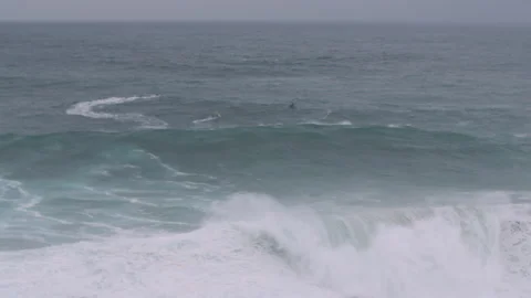 Slow motion of raging ocean waves swaying towards solid ground on cloudy day Stock Footage 156085323