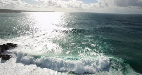 Slow motion of raging ocean waves swimming towards seashore on sunny day Stock Footage 156098253