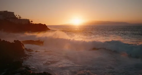 Slow-motion raging ocean waves crashing on rocks at sunset. Storm rough sea Stock Footage 239582669