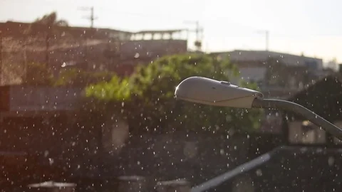 Slow motion rain and drizzle with a lamp post in foreground Stock Footage 84615340