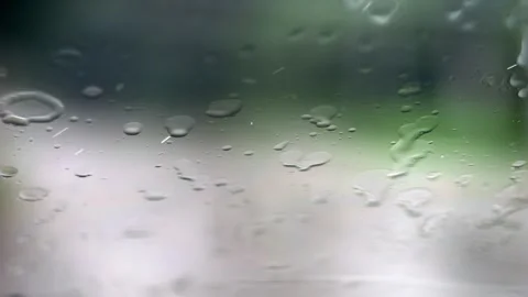 Slow-motion rain assaults the window, wipers intermittently revealing a bac.. Stock Footage 255365288