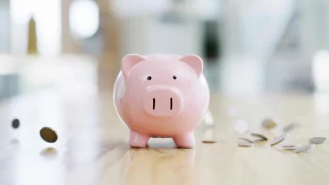 Slow motion rain of coins falling around a pink piggy bank Stock Footage 335956004