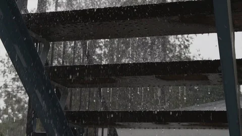 Slow motion rain dripping under stairs during storm Stock Footage 120155725