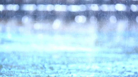 Slow motion rain droplets falling on ground on blurred background Vídeo Stock 93518435