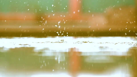 Slow motion rain droplets falling on ground on blurred background Stock-Footage 140121863