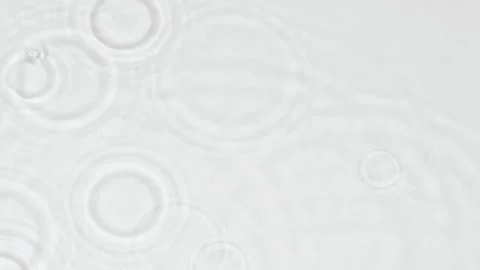 Slow motion rain drops and ripples on water surface on white abstract background Stock Footage 245134037
