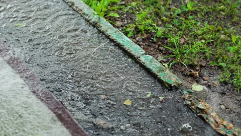 Slow motion of rain drops in the city during heavy tropical downpour, drops.. 動画素材 345147142