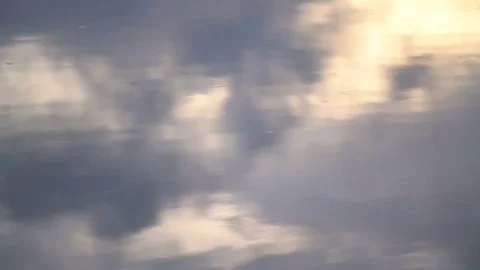 Slow motion rain drops falling on a lake in golden sunset reflection Stock Footage 83406578