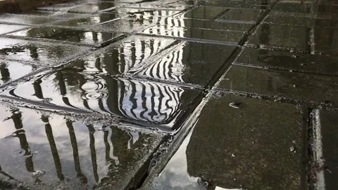 Slow motion rain drops splash on patio at slow motion. Video stock 99259084