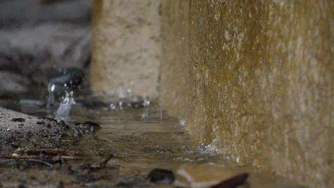 SLOW MOTION RAIN DROPS SPLASHING INTO PUDDLE Stock Footage 272509385