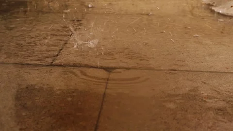 Slow Motion Rain Drops Splashing on Wet Pavement Surface Close Up Texture Stock Footage 329280744