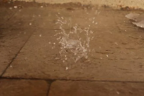 Slow Motion Rain Drops Splashing on Wet Pavement Surface Close Up Texture Stock Photos