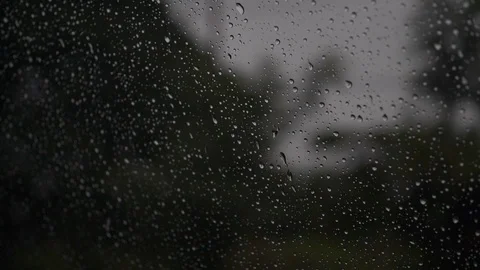 Slow motion, rain drops on window car with driving on dark road Stock Footage 93776386